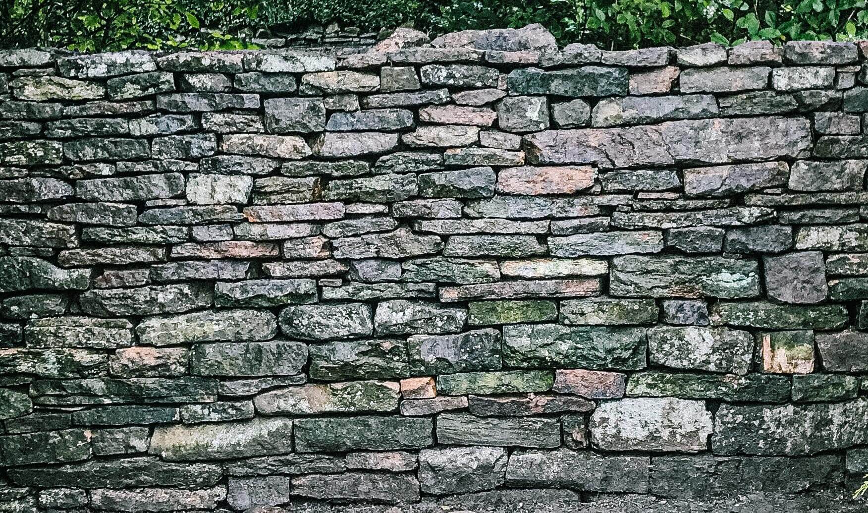 Dry stone walling - A close up photo of a grit stone dry stone wall in Sheffield